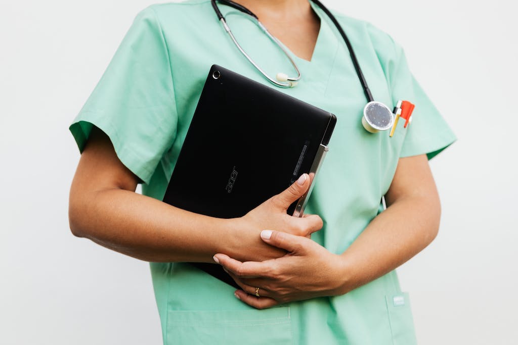 A Nurse Holding a Digital Tablet